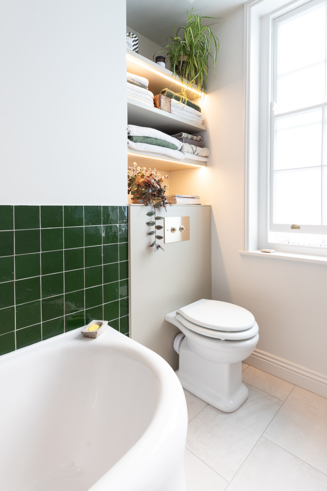 Photo of a mid-sized bathroom in London with a corner shower, white walls, ceramic floors, a wall-mount sink, grey floor, a sliding shower screen, a niche and a single vanity.