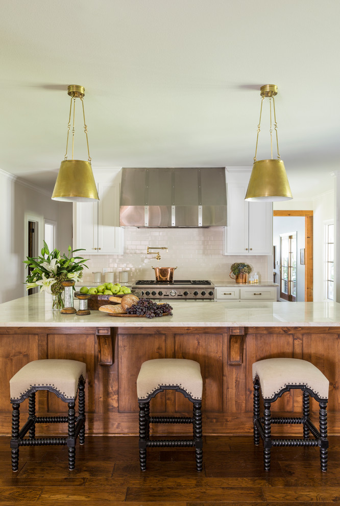 Inspiration for a large country kitchen in Little Rock with an undermount sink, shaker cabinets, white cabinets, quartzite benchtops, white splashback, subway tile splashback, panelled appliances, dark hardwood floors and with island.