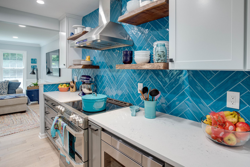 Inspiration for a mid-sized transitional galley kitchen remodel in DC Metro with an undermount sink, shaker cabinets, quartz countertops, blue backsplash, stainless steel appliances and no island