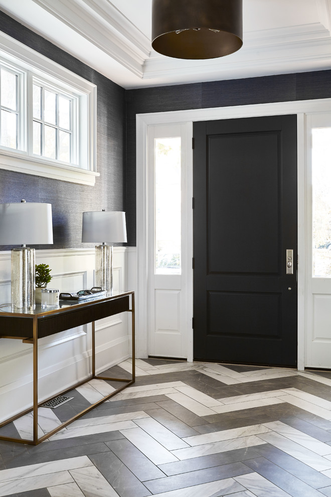 This is an example of a transitional foyer in Toronto with porcelain floors, a single front door, grey floor, grey walls and a black front door.