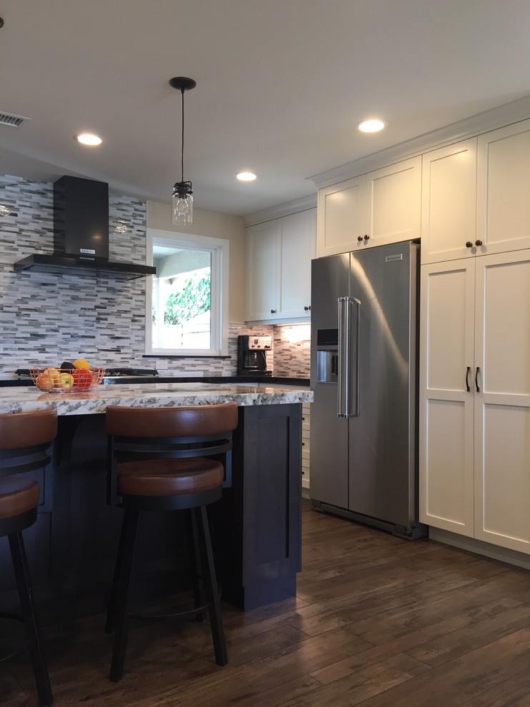 Inspiration for a transitional brown floor kitchen remodel in Orange County with shaker cabinets, white cabinets, granite countertops, an island and multicolored countertops