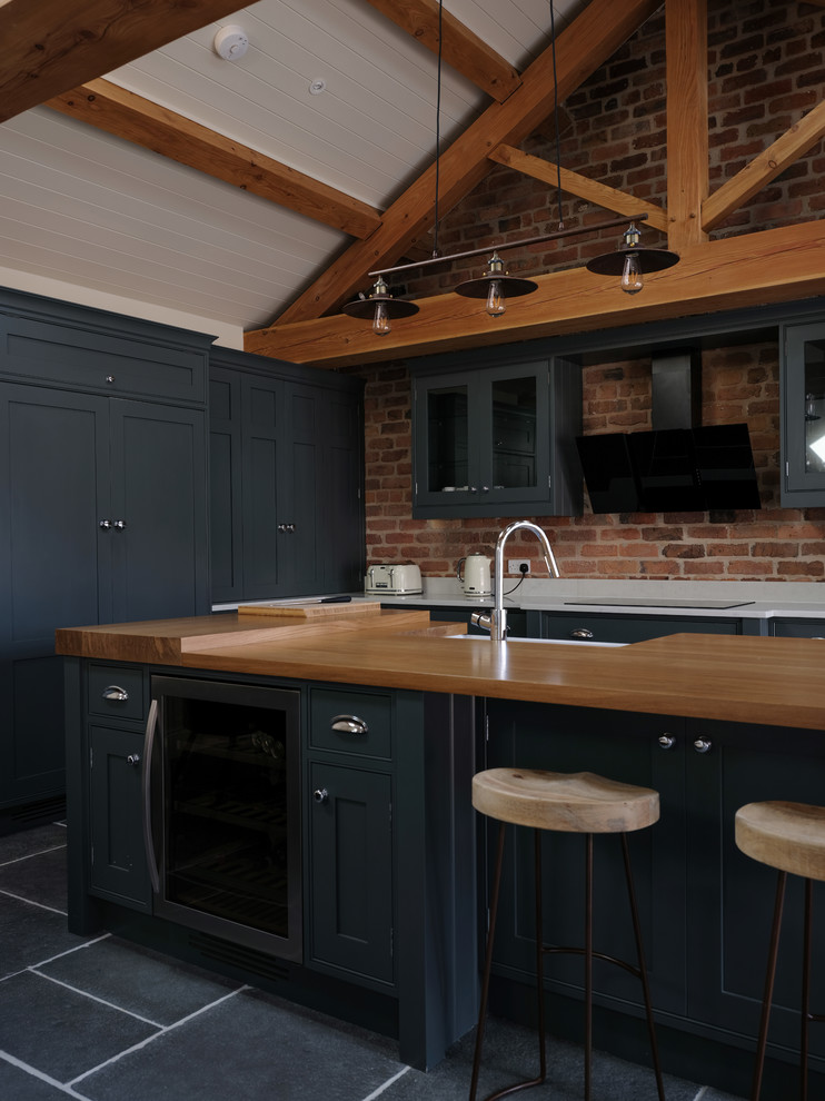 This is an example of a transitional kitchen in Cheshire with quartzite benchtops, slate floors, with island and grey floor.