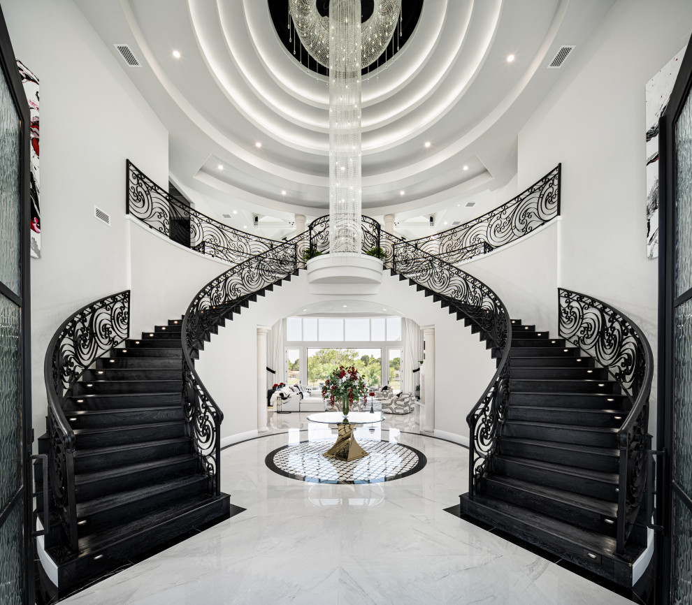 Photo of an expansive modern foyer in Phoenix with a double front door, white walls, marble floors, a black front door, white floor and coffered.