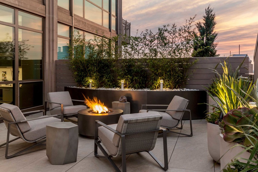Photo of a contemporary patio in Chicago with a fire feature, concrete slab and no cover.