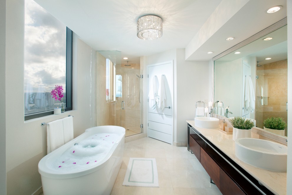 Photo of a contemporary bathroom in Miami with a freestanding tub and a vessel sink.