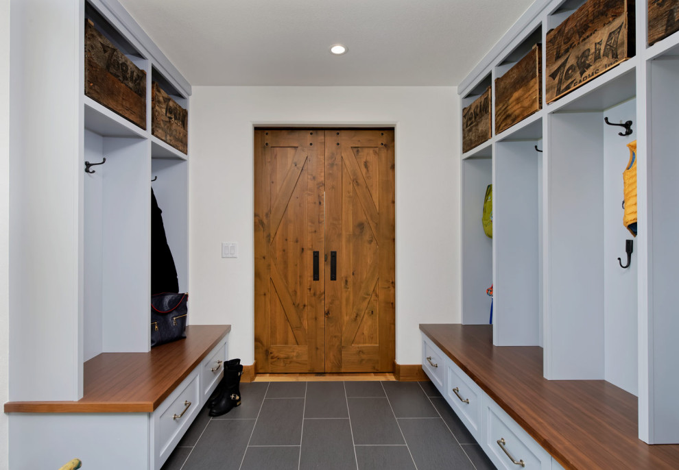 Mid-sized mountain style medium tone wood floor front door photo with a medium wood front door