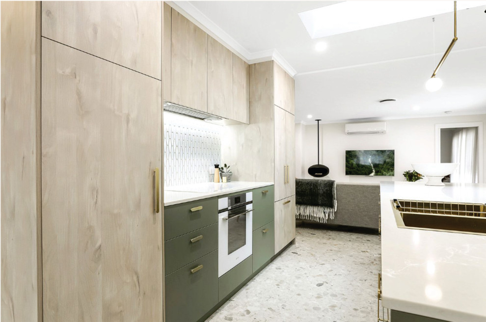 Photo of a beach style kitchen in Melbourne with with island.