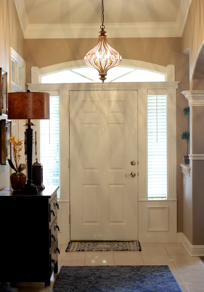 Inspiration for a mid-sized traditional foyer in Other with beige walls, ceramic floors, a single front door, a white front door and beige floor.