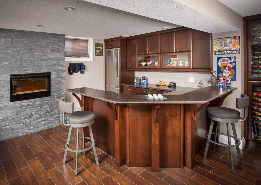 Large transitional u-shaped seated home bar in Toronto with flat-panel cabinets, medium wood cabinets, terrazzo benchtops, medium hardwood floors and brown floor.