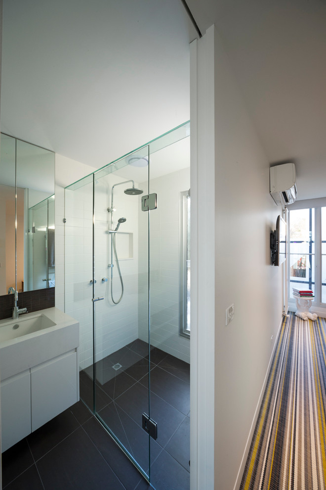 Small contemporary master bathroom in Melbourne with raised-panel cabinets, white cabinets, a double shower, a one-piece toilet, white tile, ceramic tile, white walls, ceramic floors, an integrated sink and engineered quartz benchtops.