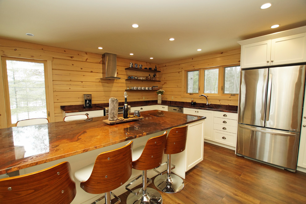 Photo of a mid-sized country l-shaped eat-in kitchen in Other with an undermount sink, shaker cabinets, white cabinets, granite benchtops, brown splashback, timber splashback, stainless steel appliances, medium hardwood floors, with island, brown floor and orange benchtop.