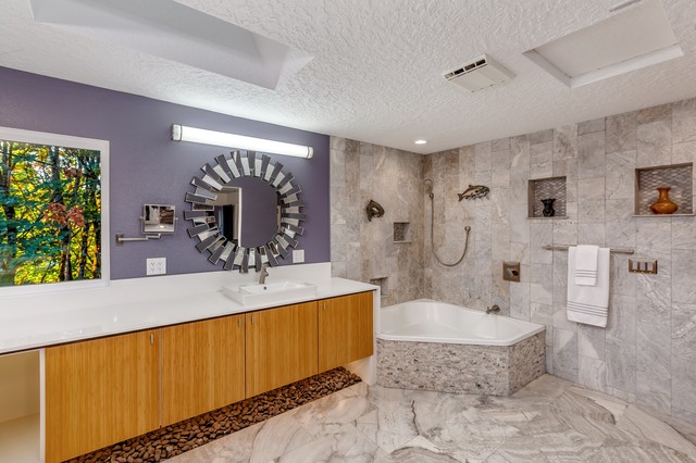 Example of a large minimalist master travertine floor and gray floor bathroom design in Portland with flat-panel cabinets, light wood cabinets, a one-piece toilet, purple walls, a drop-in sink, engineered quartz countertops and white countertops