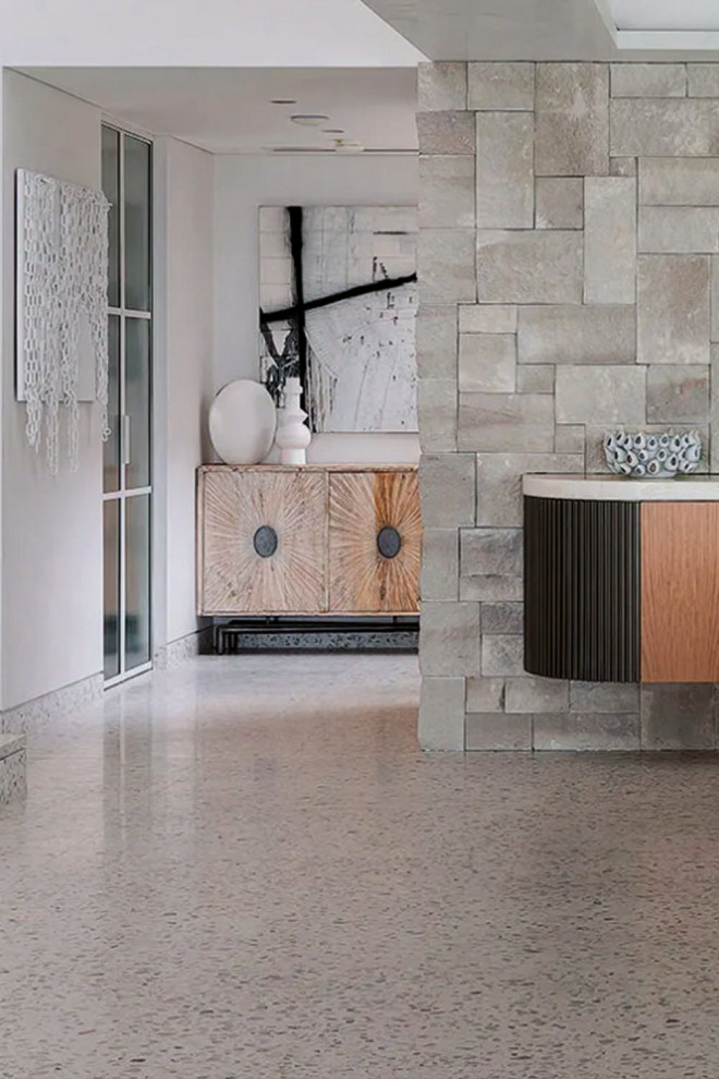 Inspiration for a large modern hallway in Los Angeles with grey walls, terrazzo floors and grey floor.