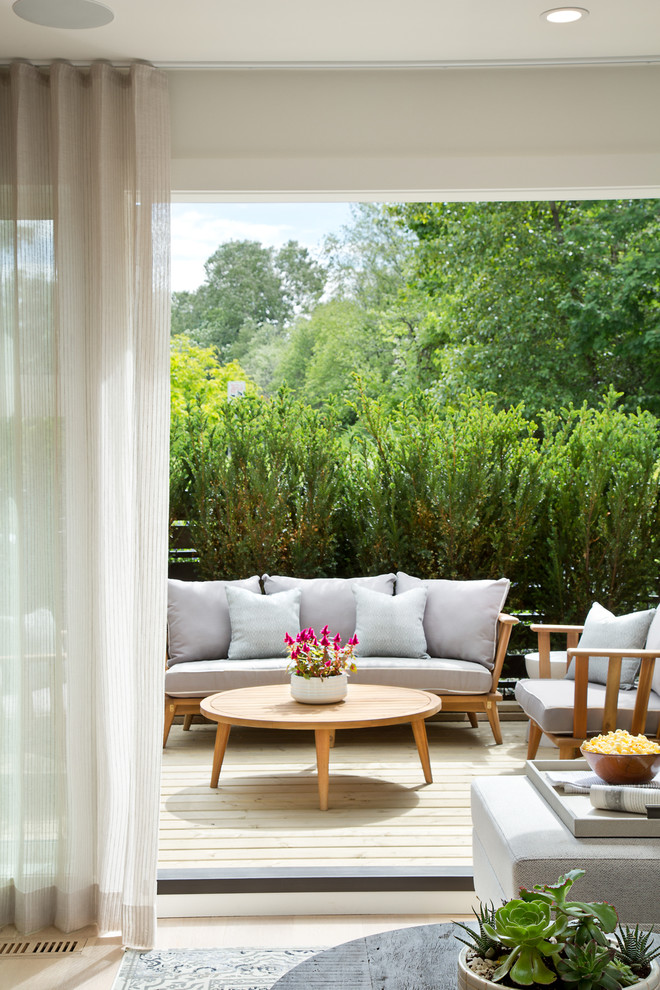 Example of a small transitional front yard deck container garden design in Vancouver with decking and no cover
