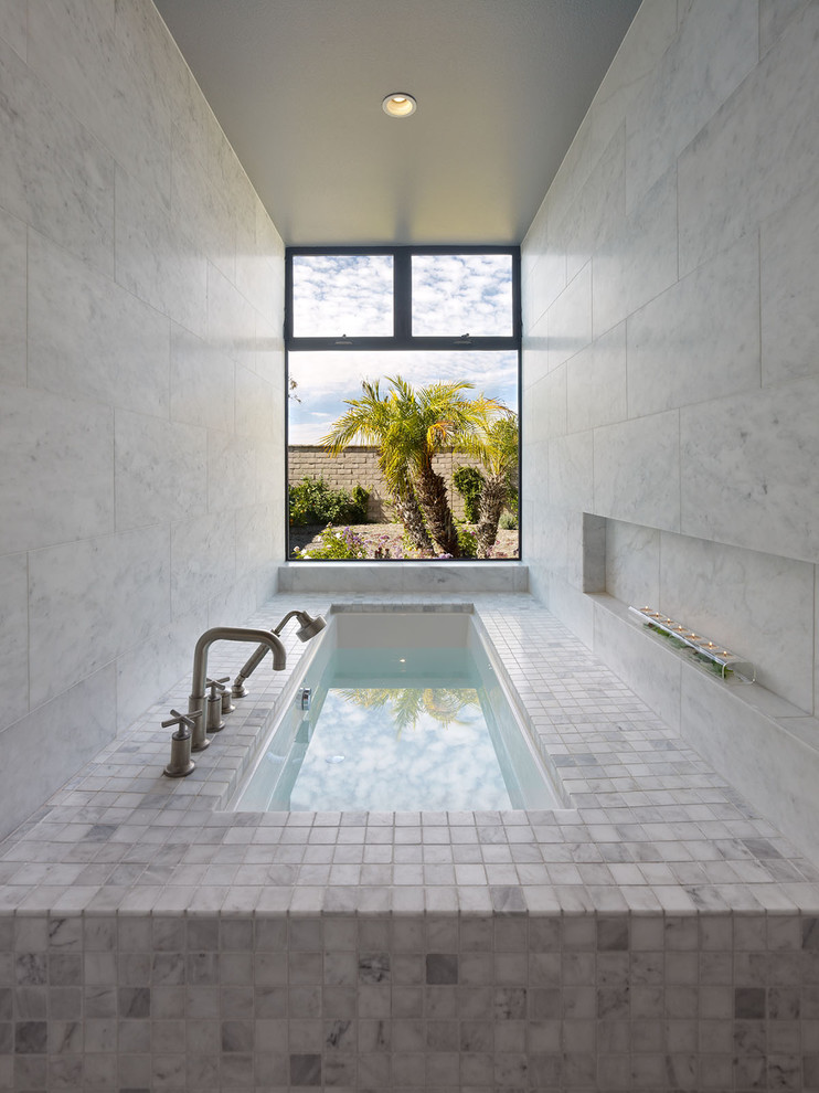 Inspiration for a contemporary bathroom in Orange County with stone tile.