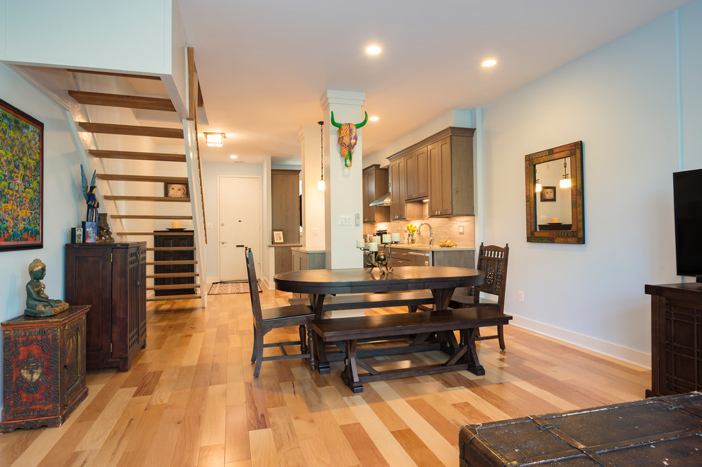 Inspiration for a mid-sized beach style open plan dining in DC Metro with light hardwood floors.