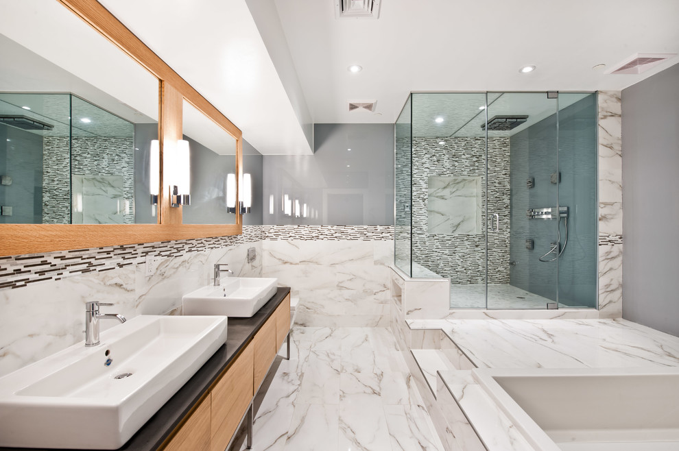 Design ideas for a contemporary master bathroom in New York with a wall-mount sink, light wood cabinets, soapstone benchtops, a drop-in tub, an open shower and a wall-mount toilet.