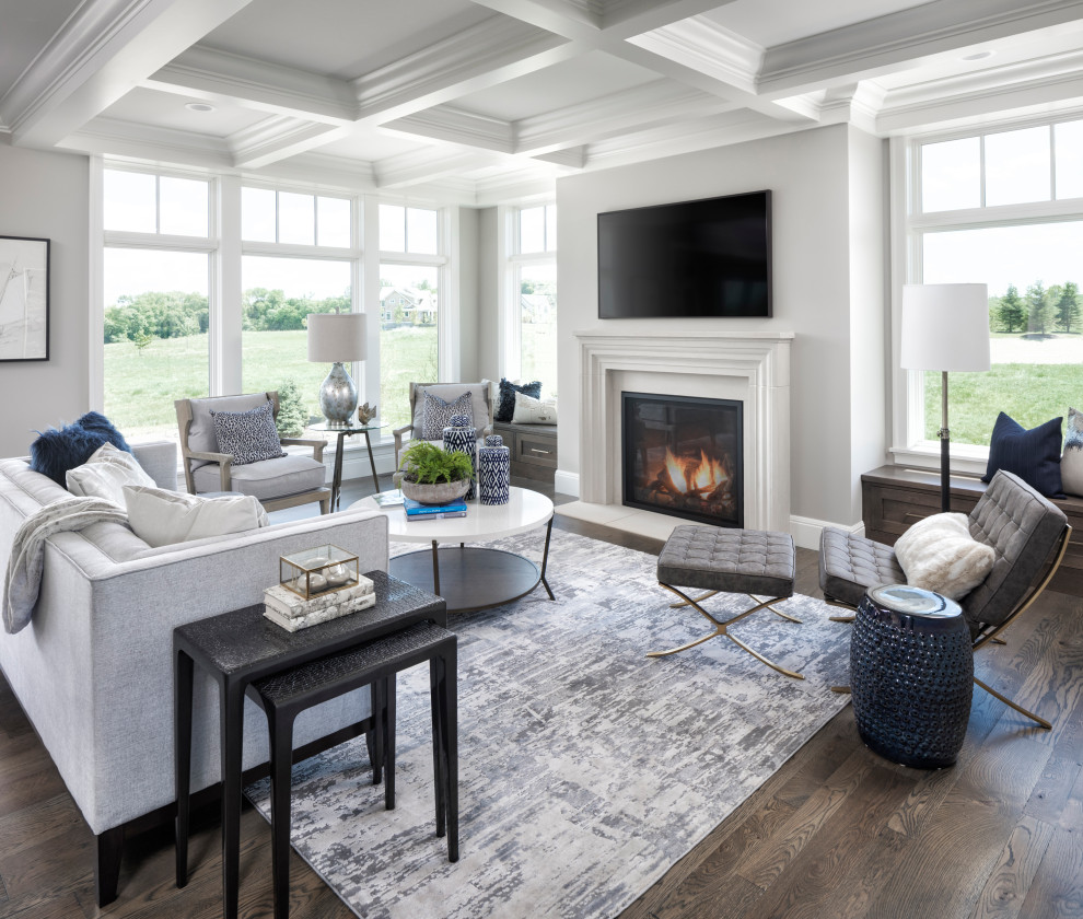 Living room - transitional open concept medium tone wood floor, brown floor and exposed beam living room idea in Minneapolis with gray walls, a standard fireplace and a wall-mounted tv