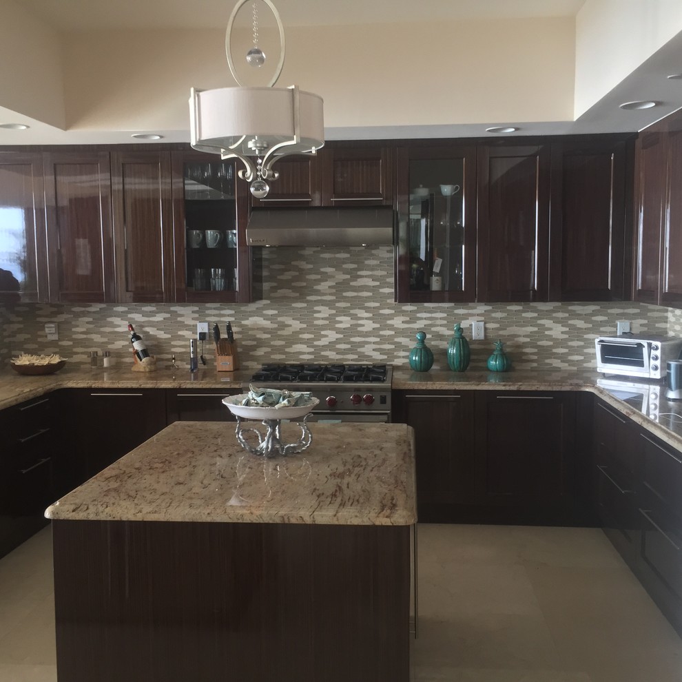 Example of a trendy marble floor eat-in kitchen design with recessed-panel cabinets, dark wood cabinets, granite countertops, beige backsplash, glass tile backsplash and stainless steel appliances