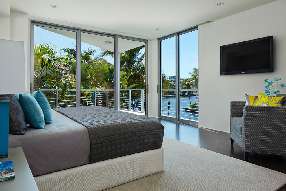 Photo of a mid-sized contemporary guest bedroom in Miami with white walls, dark hardwood floors and no fireplace.
