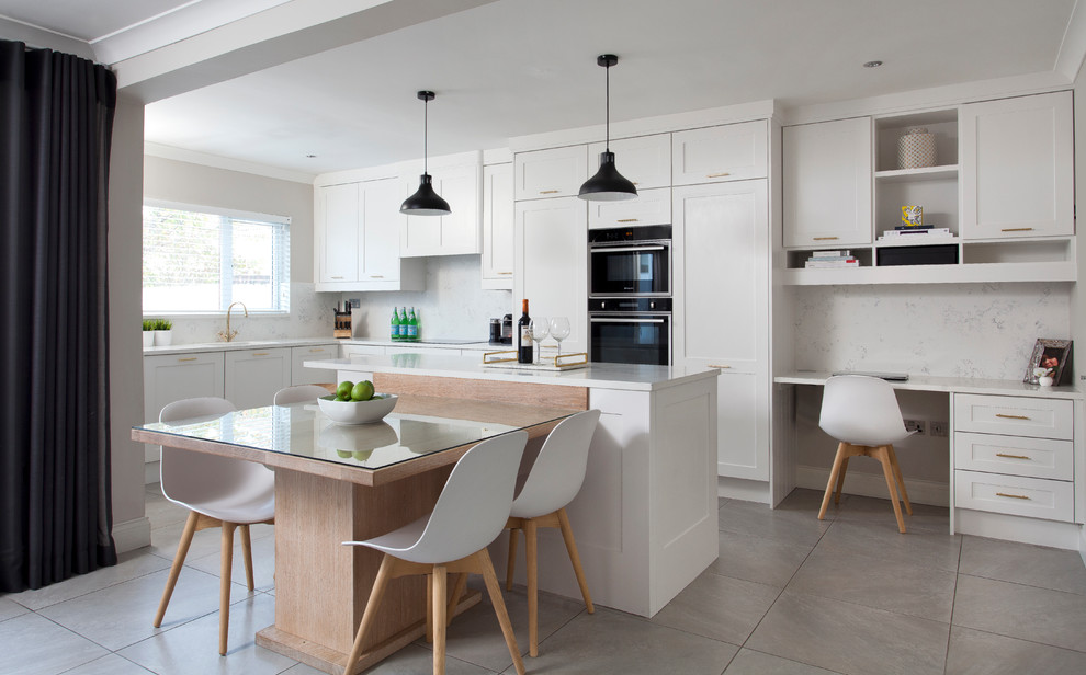 Inspiration for a mid-sized transitional l-shaped eat-in kitchen in Dublin with white cabinets, with island, an undermount sink, shaker cabinets, white splashback, black appliances, grey floor and yellow benchtop.