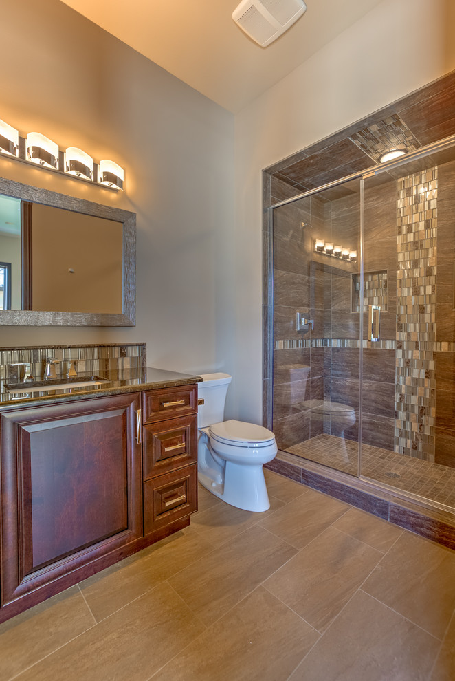 This is an example of a large contemporary bathroom in Omaha with an undermount sink, recessed-panel cabinets, medium wood cabinets, engineered quartz benchtops, a drop-in tub, a one-piece toilet, brown tile, porcelain tile, beige walls, porcelain floors and with a sauna.