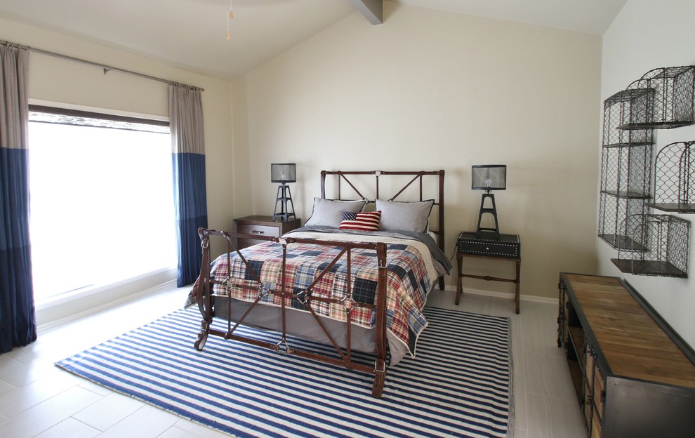 This is an example of a mid-sized beach style guest bedroom in Austin with beige walls, porcelain floors and no fireplace.