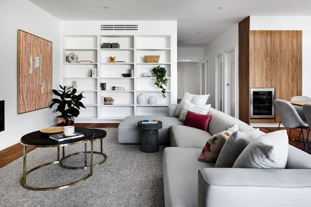Photo of a contemporary open concept living room in Melbourne with white walls, dark hardwood floors and brown floor.