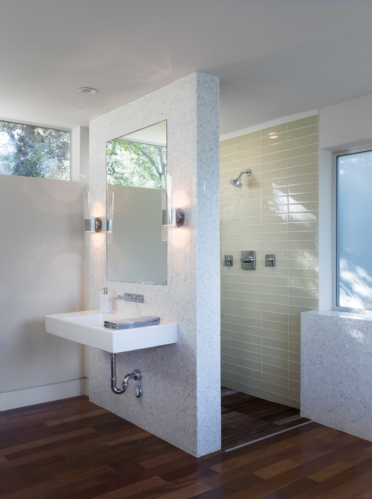 Mid-sized contemporary master bathroom in Austin with mosaic tile, a wall-mount sink, a curbless shower, white walls and dark hardwood floors.