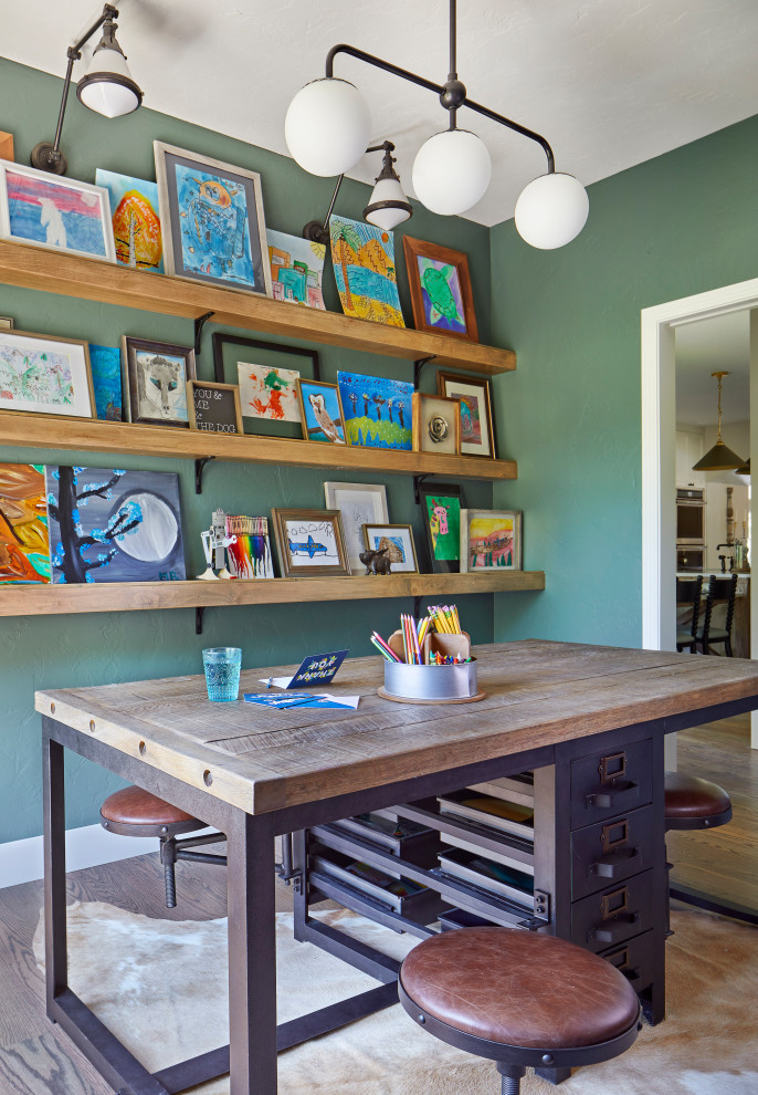 This is an example of a traditional craft room in Denver with green walls and a freestanding desk.