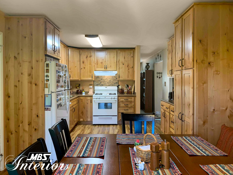 Eat-in kitchen - mid-sized rustic l-shaped light wood floor and beige floor eat-in kitchen idea with a drop-in sink, shaker cabinets, light wood cabinets, laminate countertops, multicolored backsplash, stone tile backsplash, white appliances, no island and brown countertops