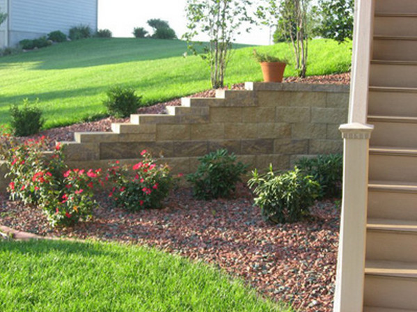 Photo of a mid-sized full sun front yard stone driveway in Omaha.