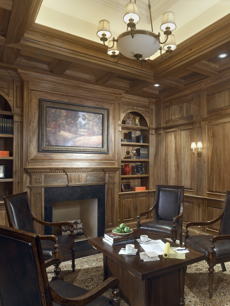 Photo of a traditional home office in Chicago with a stone fireplace surround and a standard fireplace.