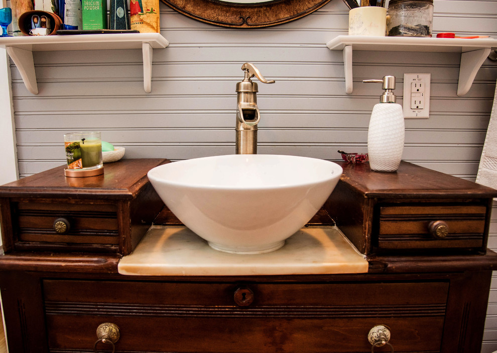 Inspiration for a mid-sized country 3/4 bathroom in Austin with flat-panel cabinets, dark wood cabinets, a two-piece toilet, grey walls, a vessel sink, wood benchtops, a claw-foot tub, a shower/bathtub combo, dark hardwood floors, brown floor and a shower curtain.
