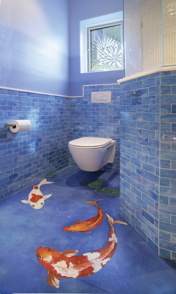 This is an example of a mid-sized beach style 3/4 bathroom in Chicago with a wall-mount toilet, blue tile and blue walls.