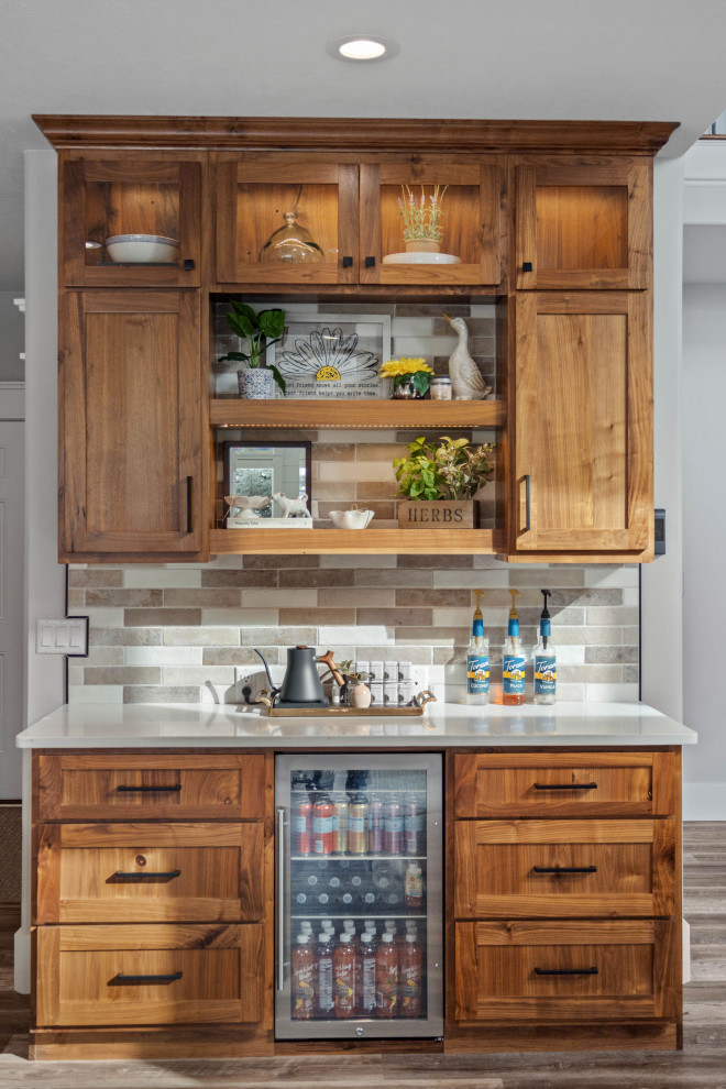 Inspiration for a large classic single-wall dry bar in Other with no sink, shaker cabinets, medium wood cabinets, engineered stone countertops, multi-coloured splashback, brick splashback, medium hardwood flooring, brown floors and white worktops.