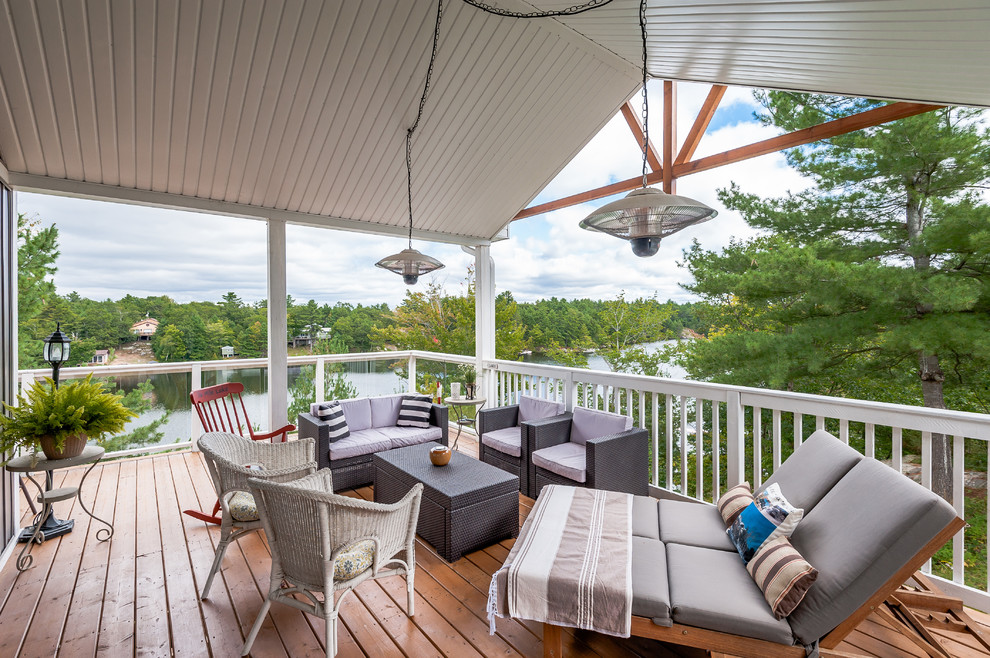 Deck - mid-sized transitional backyard deck idea with a roof extension