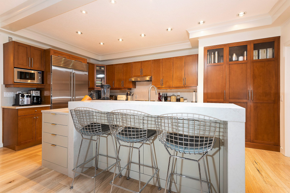 Example of a transitional kitchen design in Calgary