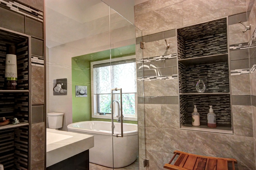 Mid-sized contemporary master bathroom in Other with a freestanding tub, an open shower, gray tile, porcelain floors and an integrated sink.