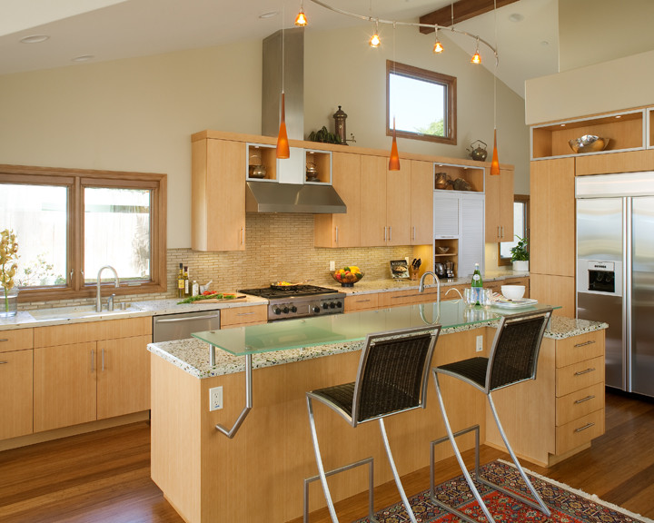 Design ideas for a large contemporary single-wall eat-in kitchen in San Diego with an undermount sink, flat-panel cabinets, light wood cabinets, recycled glass benchtops, porcelain splashback, stainless steel appliances, medium hardwood floors, with island and beige splashback.