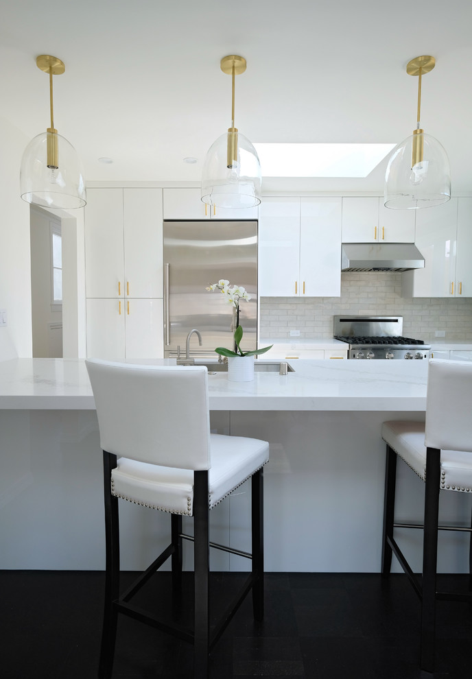 Mid-sized contemporary single-wall eat-in kitchen in San Francisco with an undermount sink, flat-panel cabinets, white cabinets, quartz benchtops, white splashback, stone tile splashback, stainless steel appliances, painted wood floors, with island and black floor.