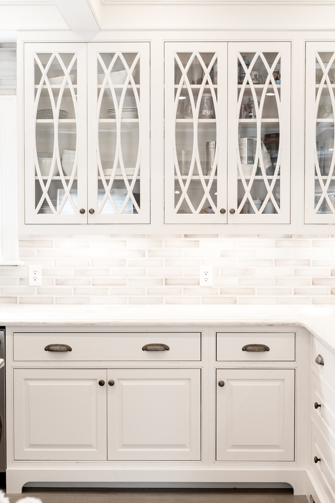Inspiration for a large traditional u-shaped kitchen in Indianapolis with raised-panel cabinets and white cabinets.
