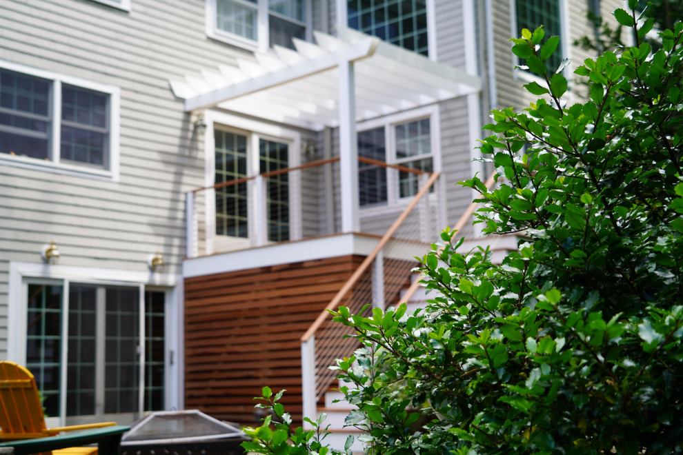 Photo of a medium sized contemporary side ground level wire cable railing terrace in Boston with an outdoor kitchen and a pergola.