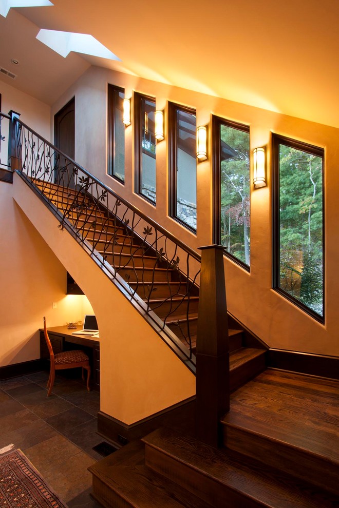 This is an example of an expansive transitional wood straight staircase in Other with wood risers.