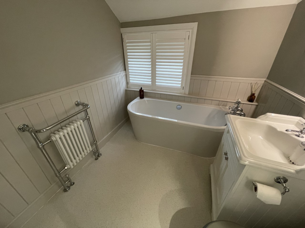Mid-sized traditional kids bathroom in Other with shaker cabinets, white cabinets, a freestanding tub, a corner shower, a sliding shower screen, a single vanity and a freestanding vanity.