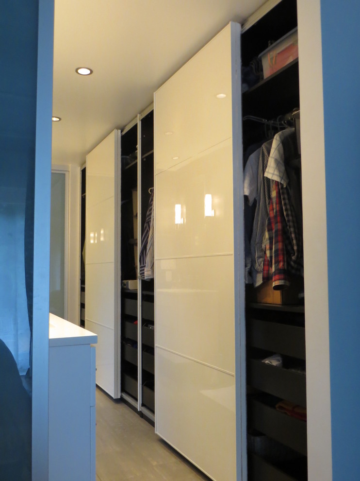 Design ideas for a modern built-in wardrobe in Miami with flat-panel cabinets, white cabinets and porcelain floors.