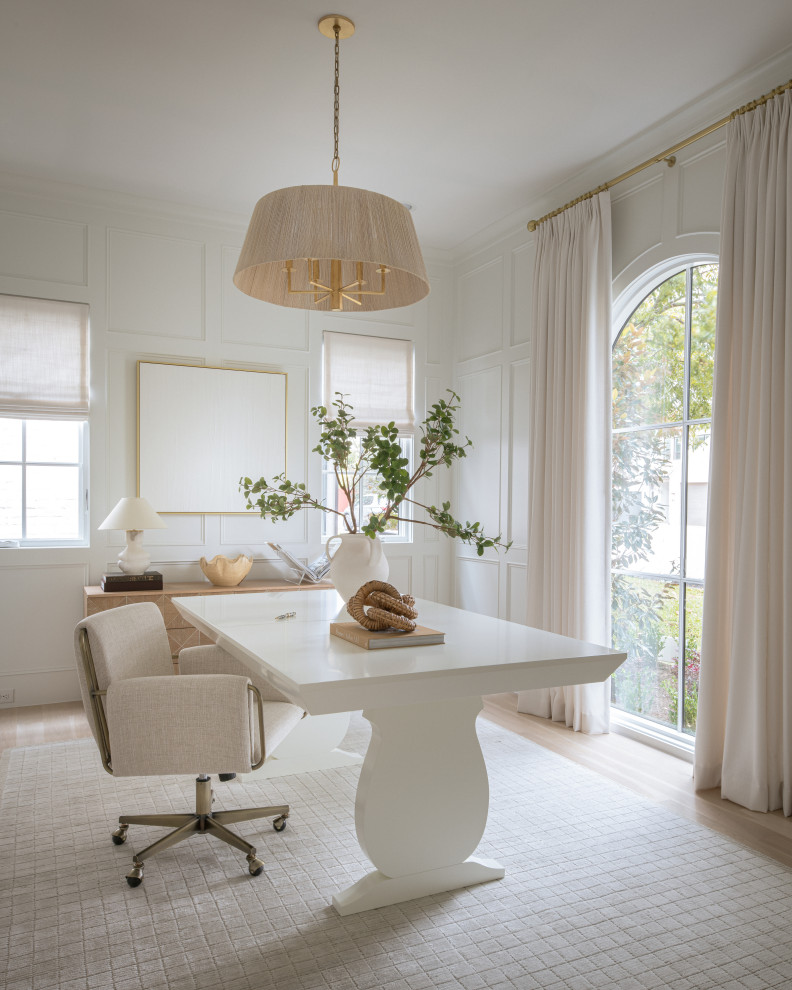 Home office - transitional freestanding desk light wood floor, beige floor and wall paneling home office idea in Dallas with white walls