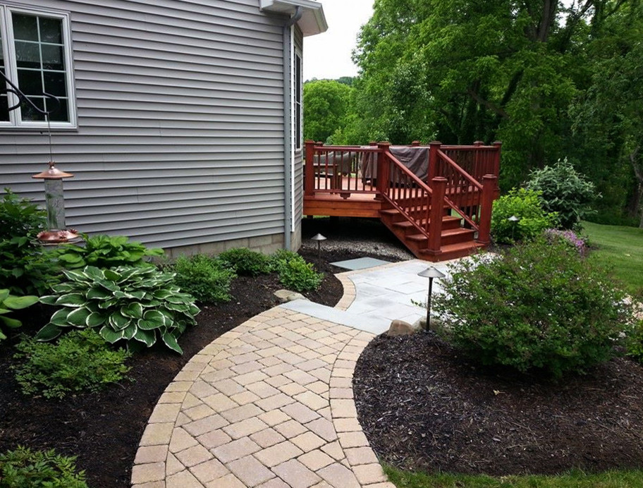 Mid-sized transitional front yard full sun formal garden in New York with a garden path and brick pavers for summer.