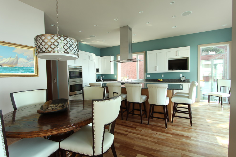 This is an example of a mid-sized transitional open plan dining in Other with grey walls and light hardwood floors.