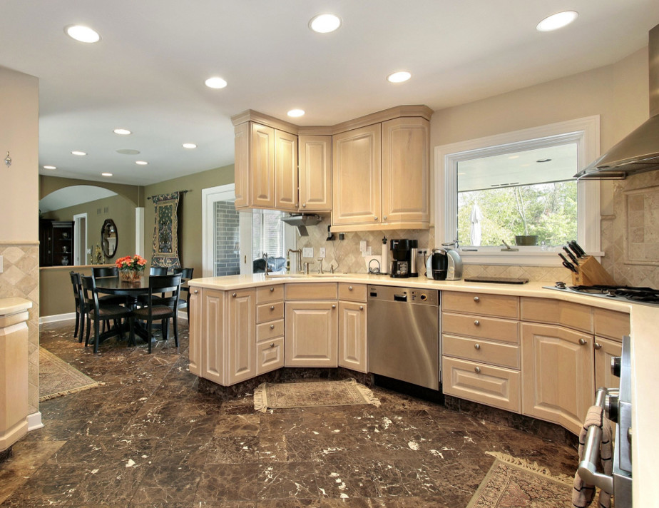 Inspiration for a mid-sized transitional u-shaped marble floor and brown floor eat-in kitchen remodel in Phoenix with raised-panel cabinets, light wood cabinets, laminate countertops, beige backsplash, ceramic backsplash, stainless steel appliances and a peninsula